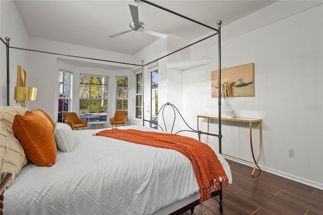 bedroom featuring dark wood-style floors, baseboards, and a ceiling fan