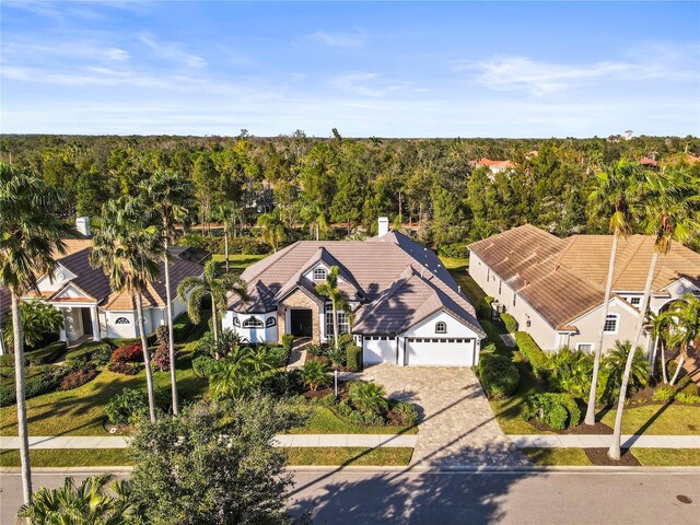 drone / aerial view with a residential view and a view of trees