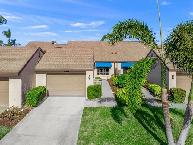 view of front of house with a garage and a front lawn