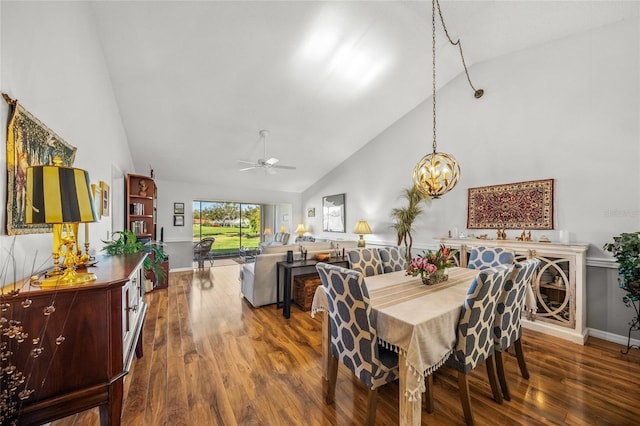 dining space with ceiling fan with notable chandelier, wood-type flooring, and high vaulted ceiling