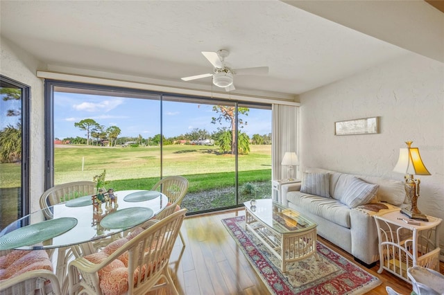 sunroom / solarium featuring ceiling fan