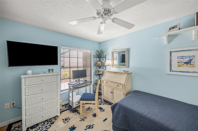 bedroom featuring ceiling fan and a textured ceiling