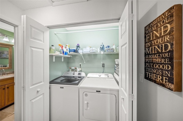 laundry area with separate washer and dryer and sink