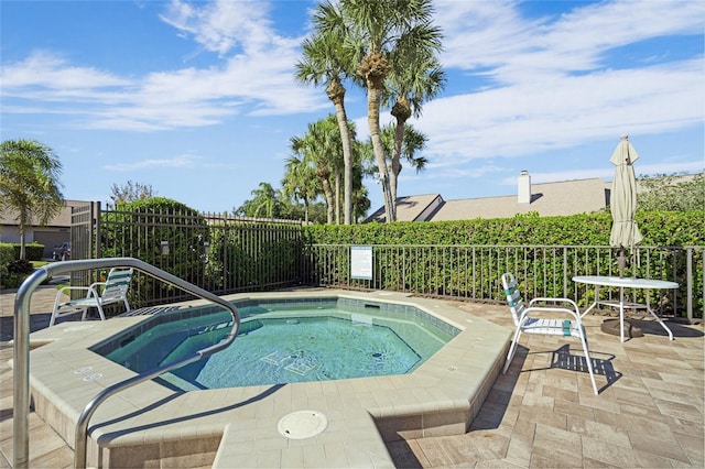 view of swimming pool featuring a community hot tub and a patio