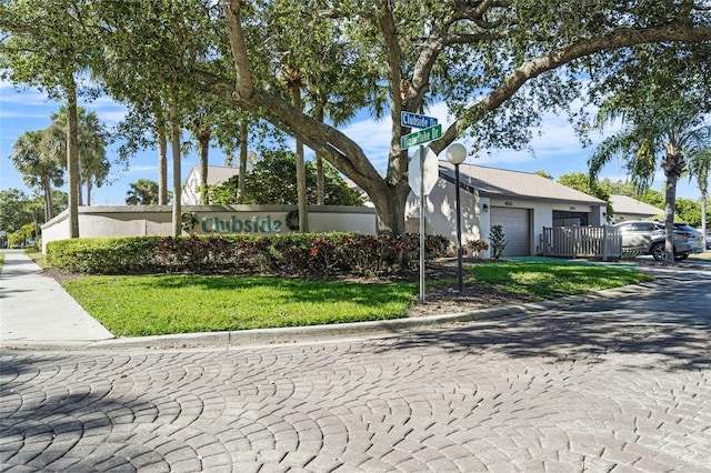 view of front of house featuring a garage and a front lawn