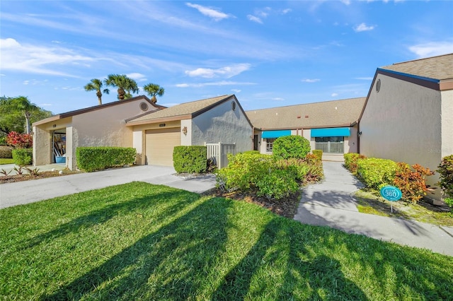 view of front of property featuring a garage and a front yard