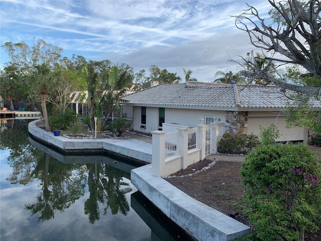 rear view of property with a water view