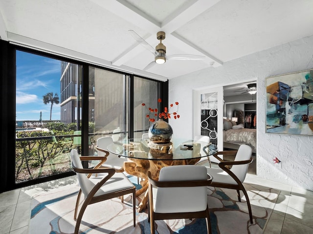 sunroom / solarium with ceiling fan and beam ceiling