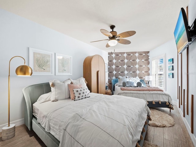 bedroom featuring hardwood / wood-style floors and ceiling fan