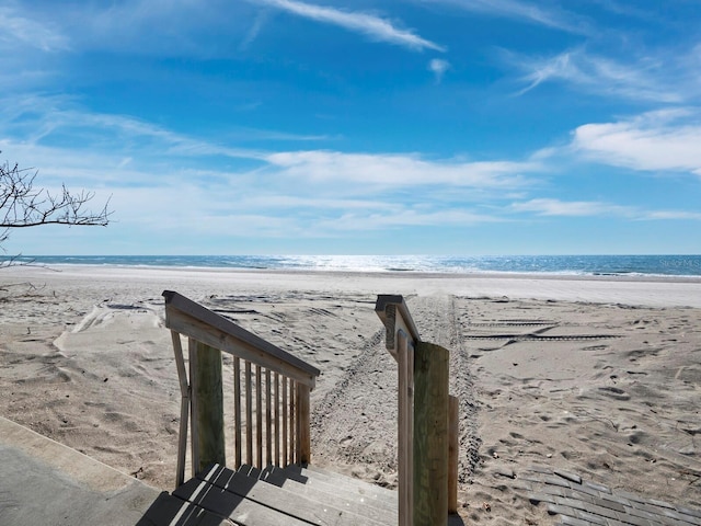 view of home's community with a beach view and a water view