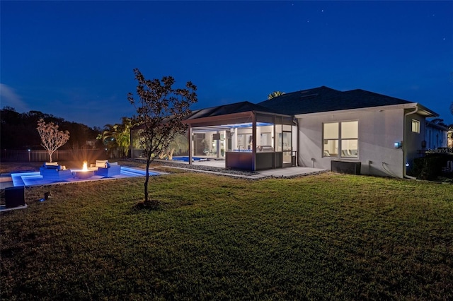 rear view of house with a pool with hot tub, a yard, a gazebo, and a patio area