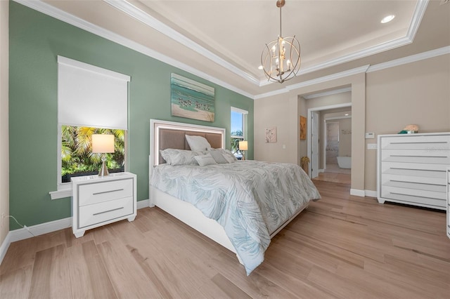 bedroom featuring ornamental molding, light wood-type flooring, and a tray ceiling