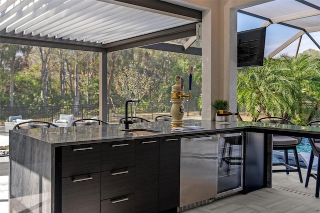 view of patio with beverage cooler and exterior bar