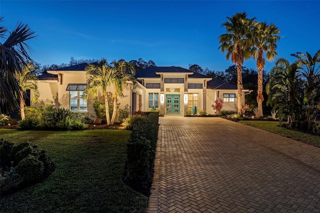 mediterranean / spanish home featuring a yard and french doors