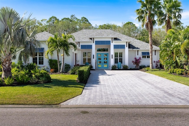 view of front facade with a front lawn and french doors