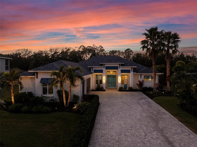 view of front of home featuring a lawn and french doors