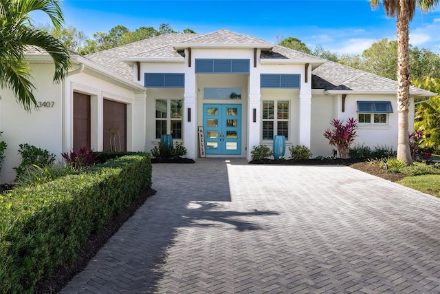 view of front of property featuring a garage and french doors