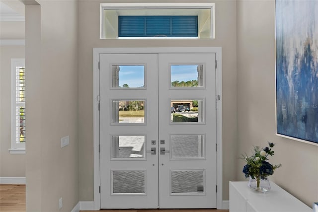 foyer with french doors and hardwood / wood-style flooring