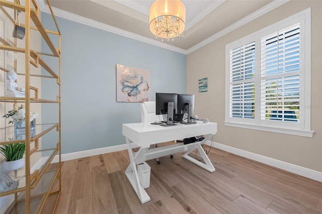 office featuring a notable chandelier, crown molding, a raised ceiling, and light wood-type flooring