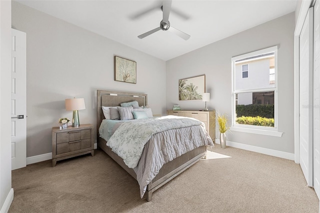 bedroom with ceiling fan and light colored carpet