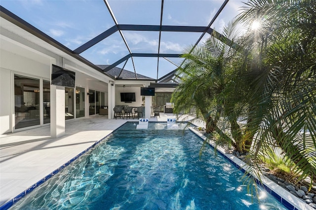 view of pool featuring pool water feature, a patio area, and a lanai