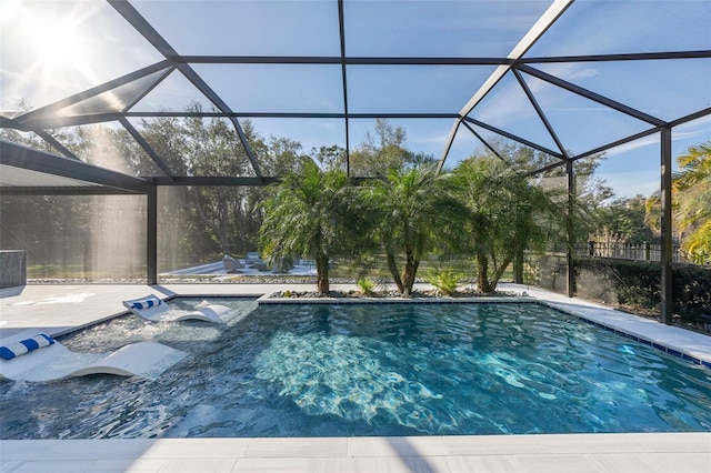 view of swimming pool featuring a lanai and a patio area