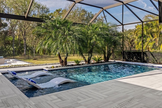 view of swimming pool featuring a patio and a lanai