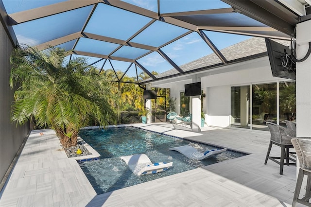 view of pool with a patio and a lanai