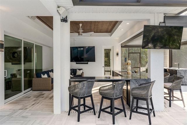 view of patio / terrace with beam ceiling, bar, and wood ceiling