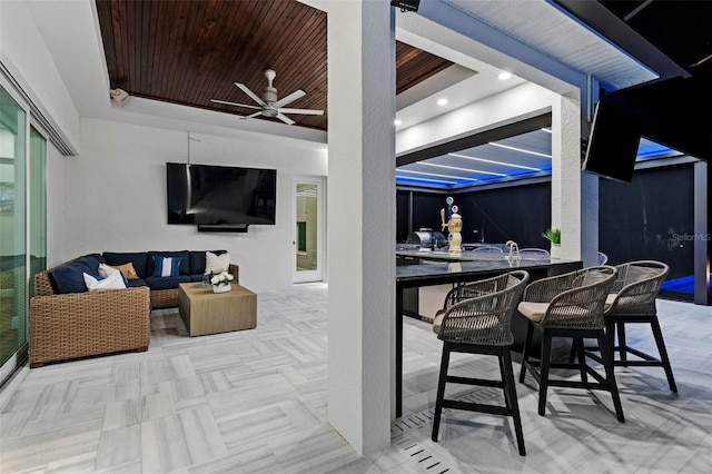 view of patio / terrace with an outdoor living space, an outdoor bar, and ceiling fan