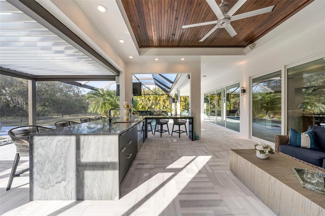 view of patio with a bar and ceiling fan