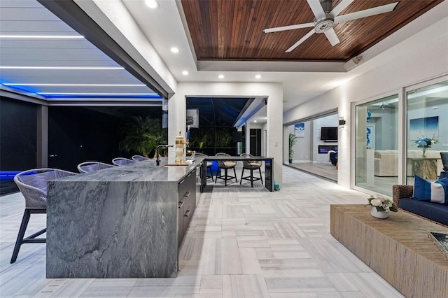 view of patio / terrace featuring a wet bar and ceiling fan