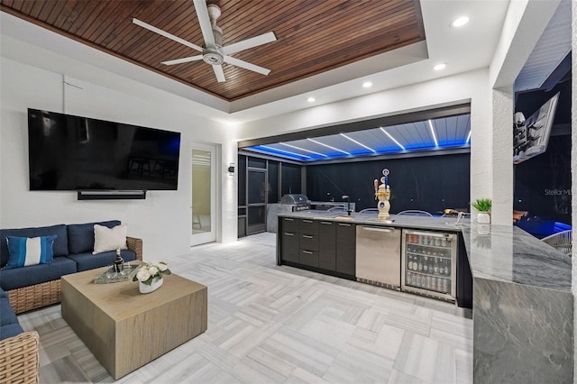 interior space featuring a patio, beverage cooler, exterior kitchen, an outdoor hangout area, and ceiling fan