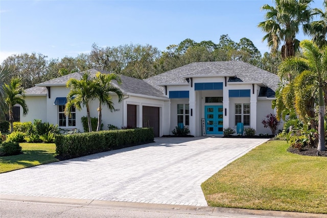 view of front of house with a garage and a front yard