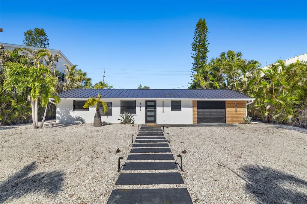 ranch-style home featuring a garage