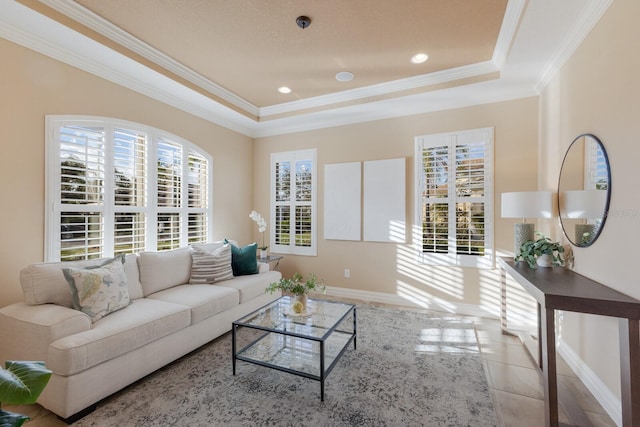 tiled living room with ornamental molding and a raised ceiling