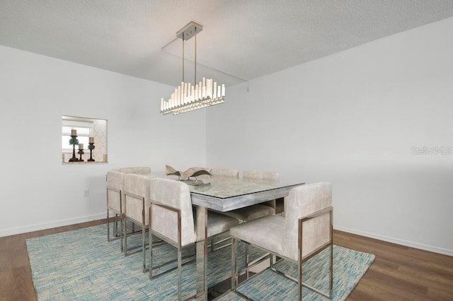 dining room featuring a notable chandelier and dark wood-type flooring