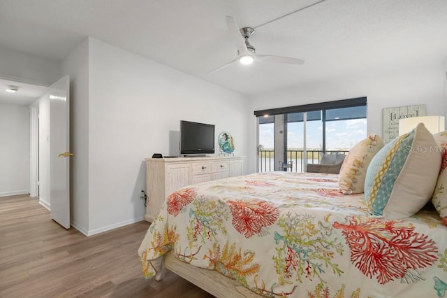 bedroom featuring access to exterior, ceiling fan, and light hardwood / wood-style floors