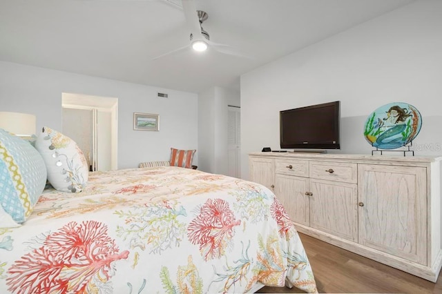 bedroom featuring dark hardwood / wood-style flooring, a closet, and ceiling fan