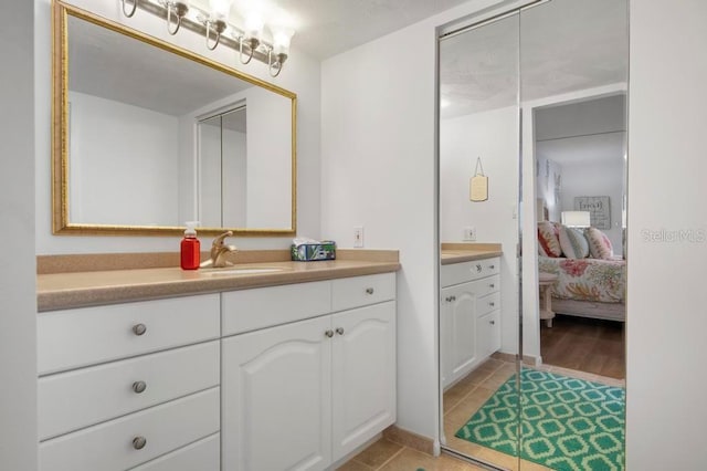 bathroom featuring tile patterned flooring and vanity