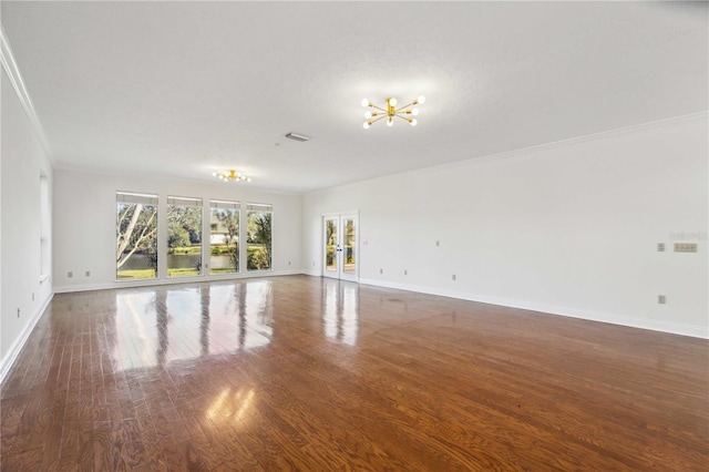 spare room with ornamental molding, dark wood-type flooring, a textured ceiling, and french doors