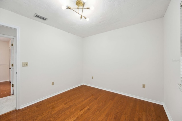 unfurnished room featuring hardwood / wood-style flooring