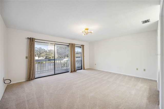 spare room featuring light colored carpet