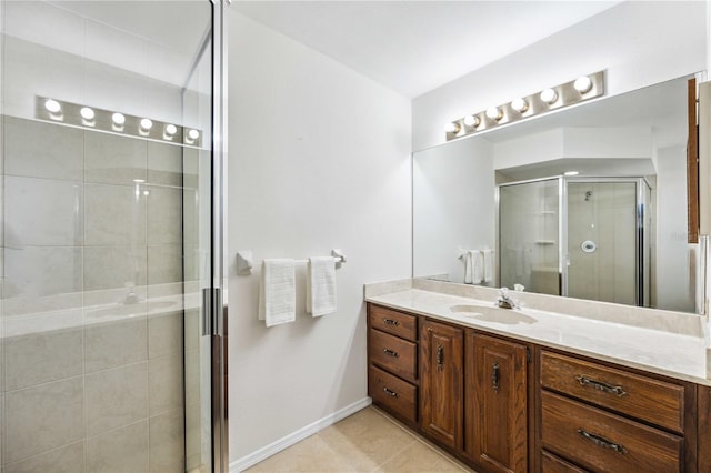 bathroom with tile patterned floors, vanity, and a shower with shower door