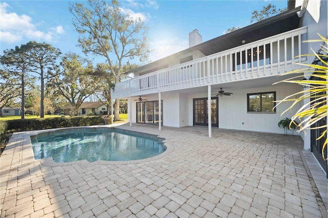 view of pool with a patio area and ceiling fan