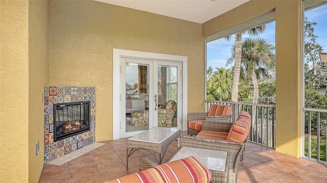 sunroom / solarium with french doors and a tiled fireplace