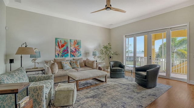 living room with hardwood / wood-style flooring, ornamental molding, french doors, and ceiling fan