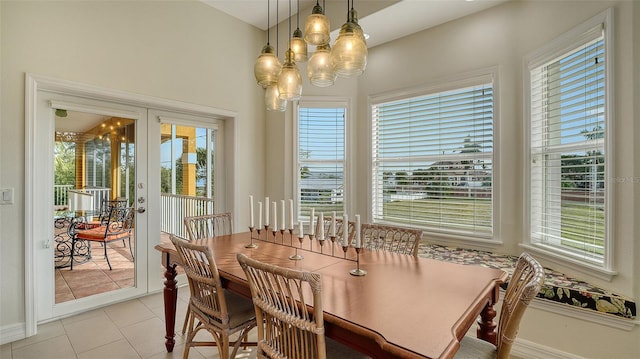 dining area with light tile patterned floors and french doors