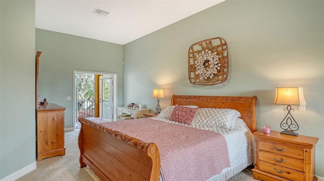 bedroom with light colored carpet and access to exterior