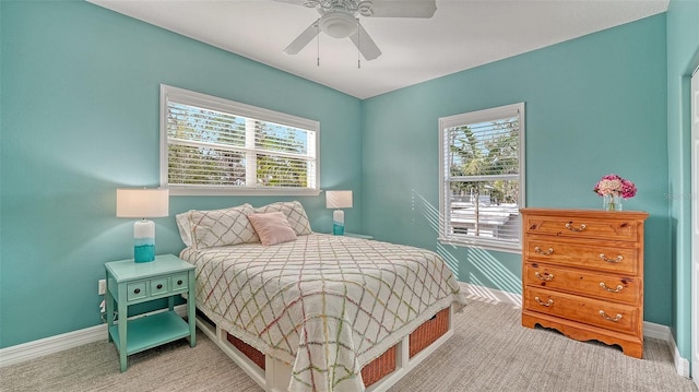 carpeted bedroom with multiple windows and ceiling fan